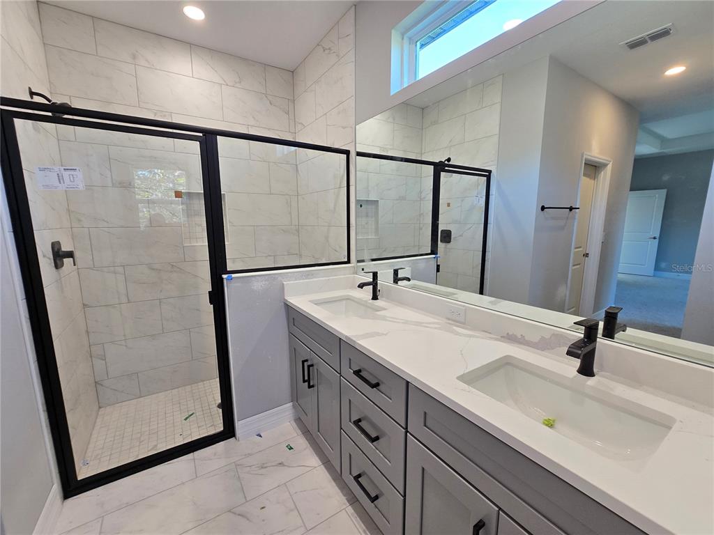 6 Calendula Court Homosassa, FL 34446 - Photo 34 of 67 a bathroom with a double vanity sink a mirror and shower