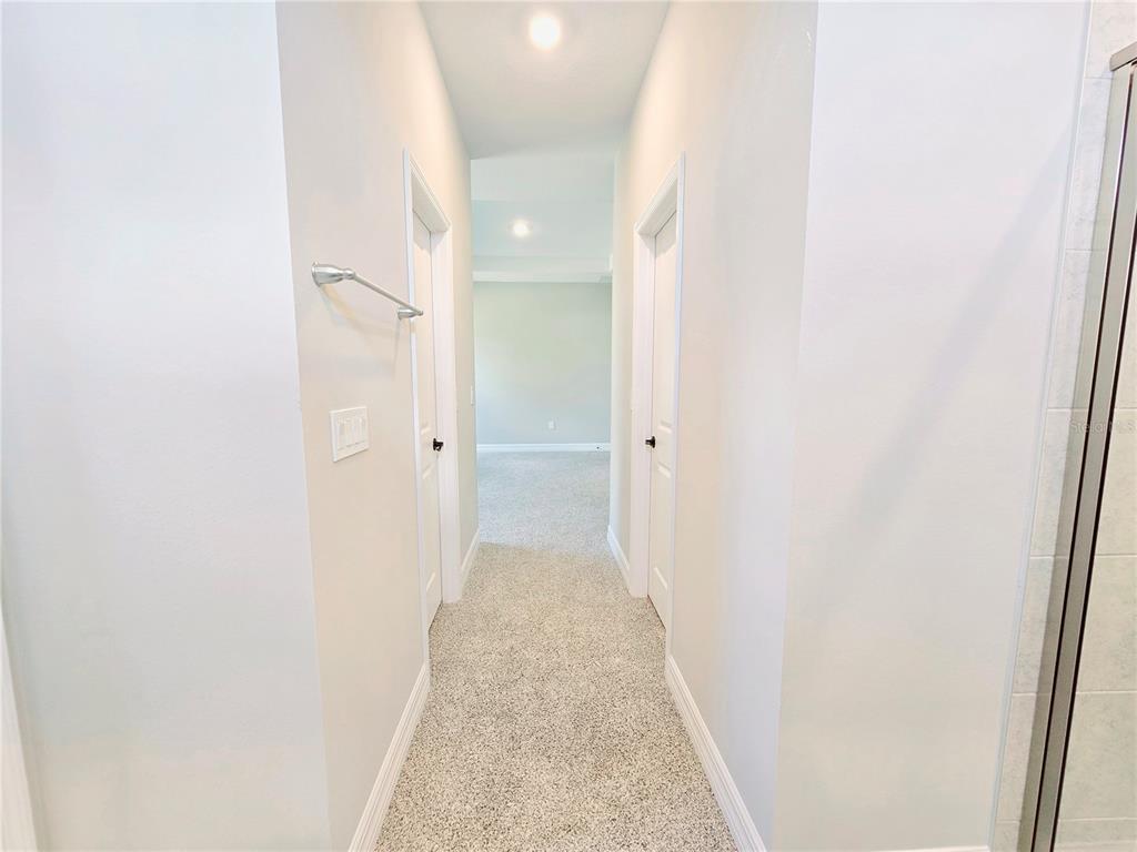 6 Calendula Court Homosassa, FL 34446 - Photo 58 of 67 a view of a hallway with wooden floor and a bathroom