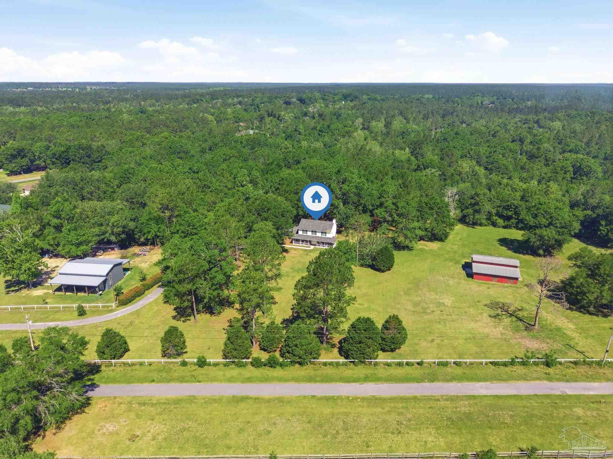 6870 Martin Road Milton, FL 32570 - Photo 47 of 48 a view of a big yard with potted plants and large trees