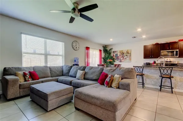 a living room with furniture a chandelier and a window