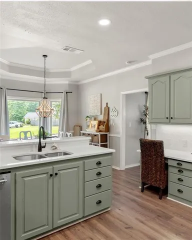 a kitchen with kitchen island granite countertop a sink window and wooden floor