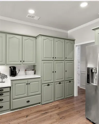 a view of a kitchen with white cabinets