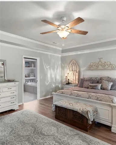 a bedroom with a bed and ceiling fan