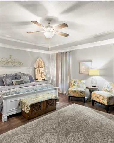 a living room with a bed and a chandelier