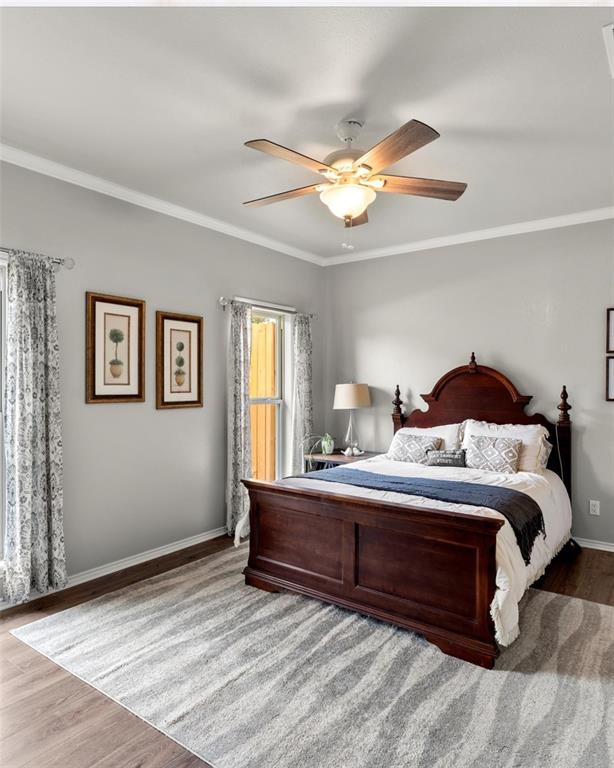 3006 Master Dr Mount Mount Pleasant, TX 75455 - Photo 25 of 34 a bedroom with a bed and a chandelier