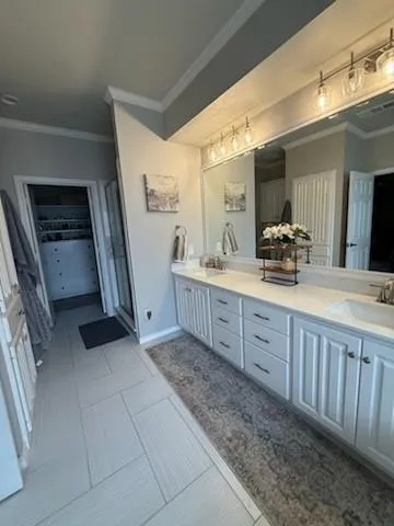 a bathroom with a double vanity sink and mirror