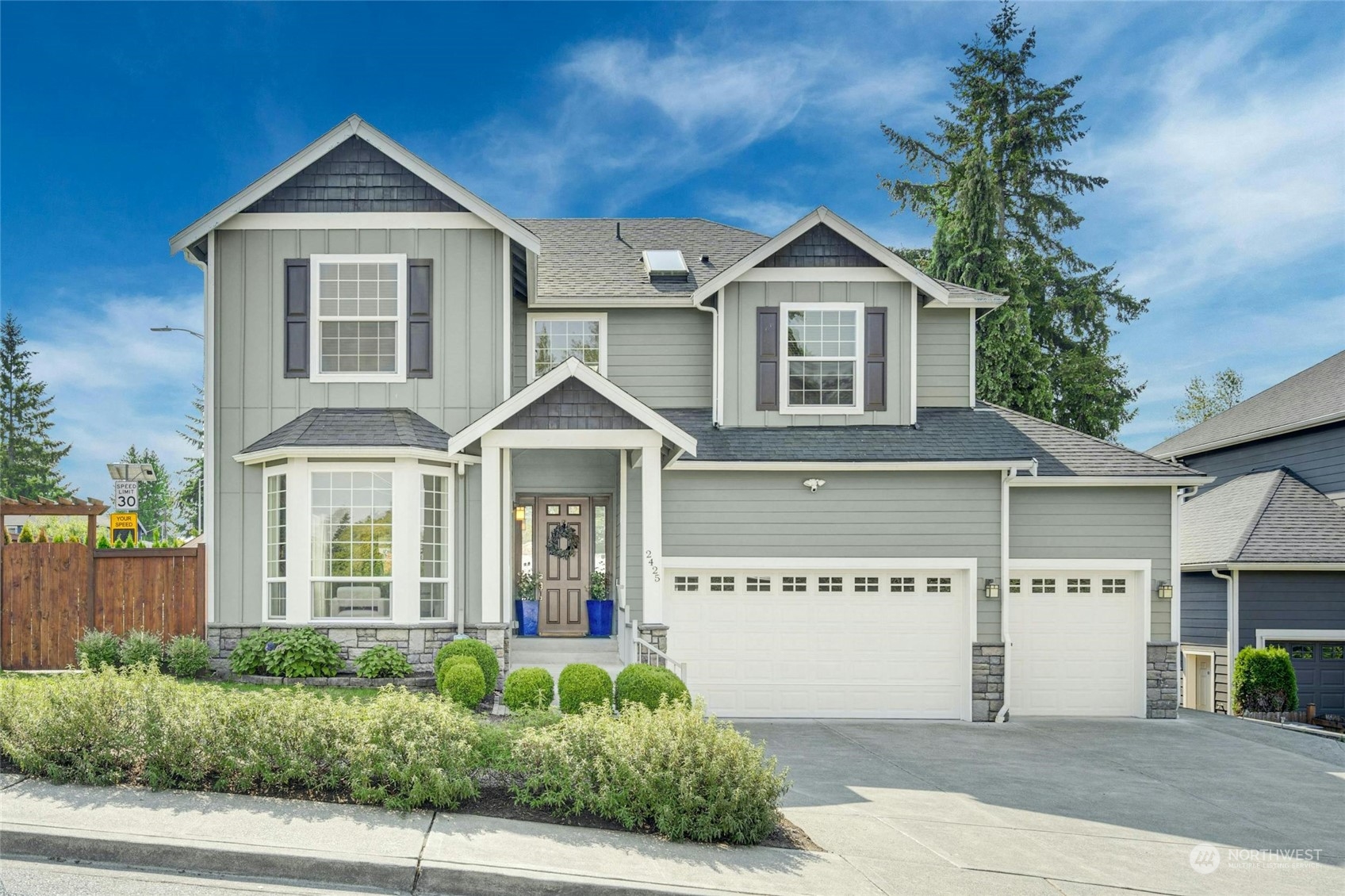 2425 Northeast 20th Street Renton, WA 98056 - Photo 1 of 39 a front view of a house with a yard and garage