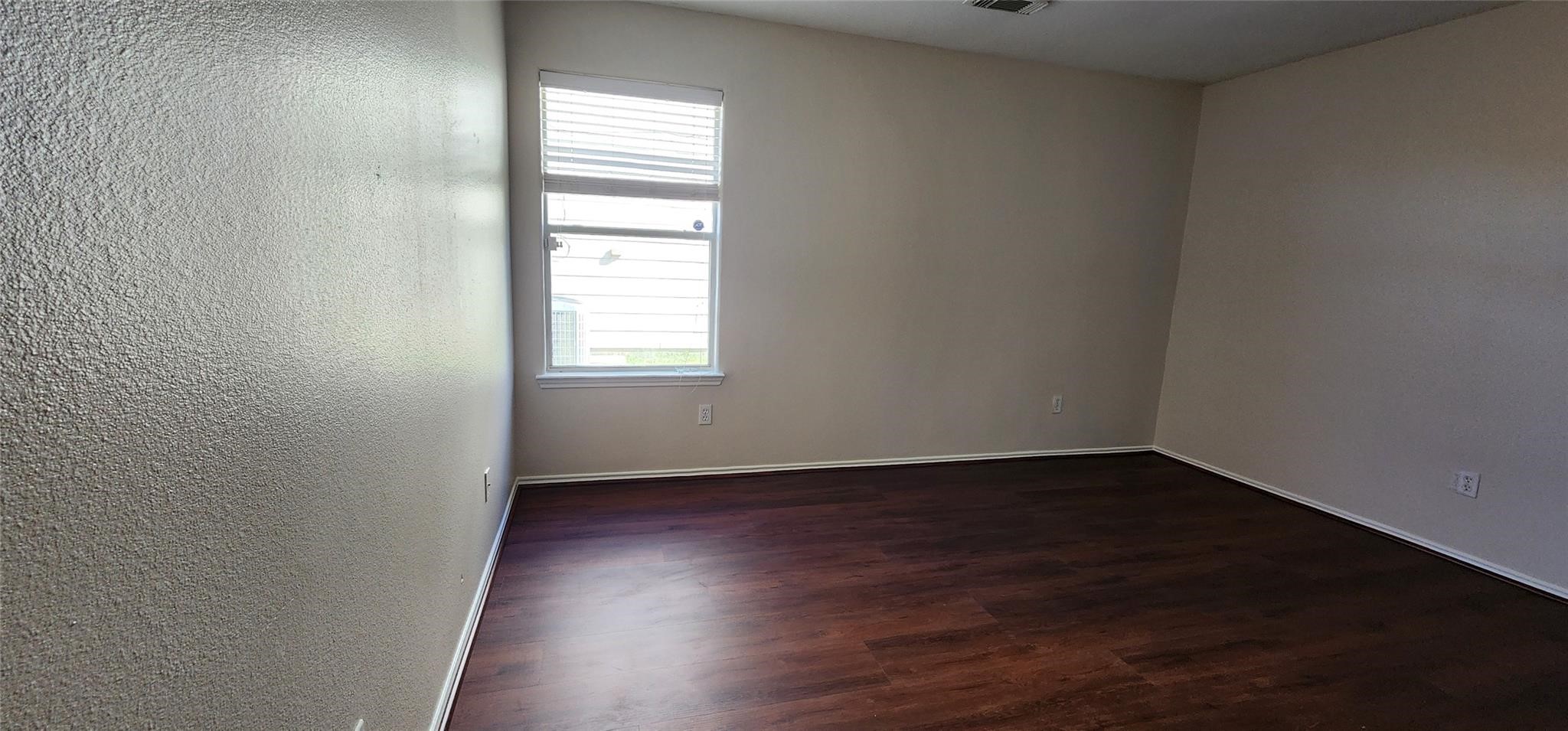 315 Sunset Colony Drive Rosharon, TX 77583 - Photo 15 of 20 an empty room with wooden floor and windows