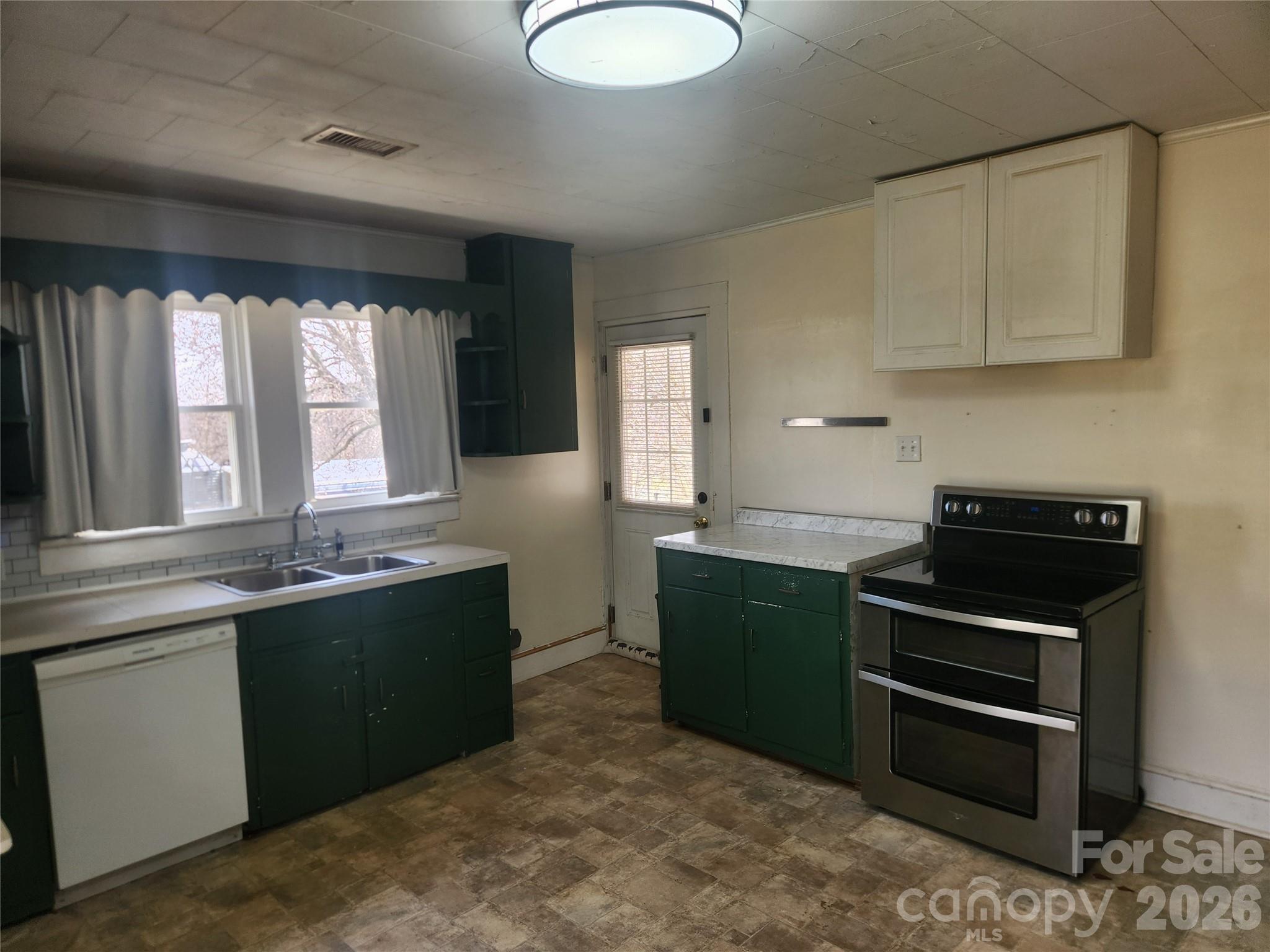 363 Center Church Road Hiddenite, NC 28636 - Photo 20 of 48 a kitchen with stainless steel appliances granite countertop a sink and cabinets