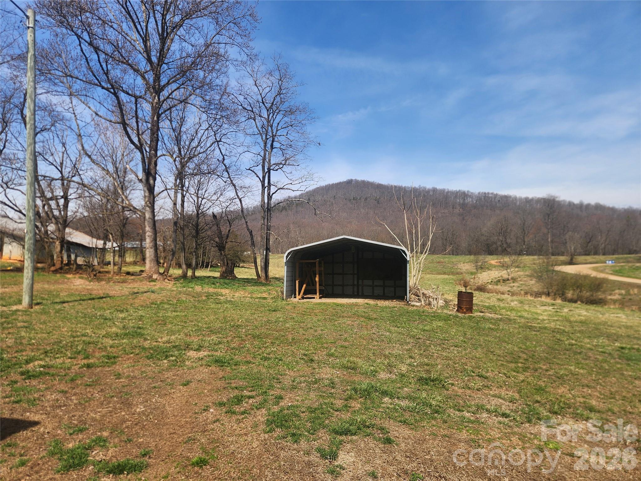 363 Center Church Road Hiddenite, NC 28636 - Photo 31 of 48 a large house with a big yard and large trees
