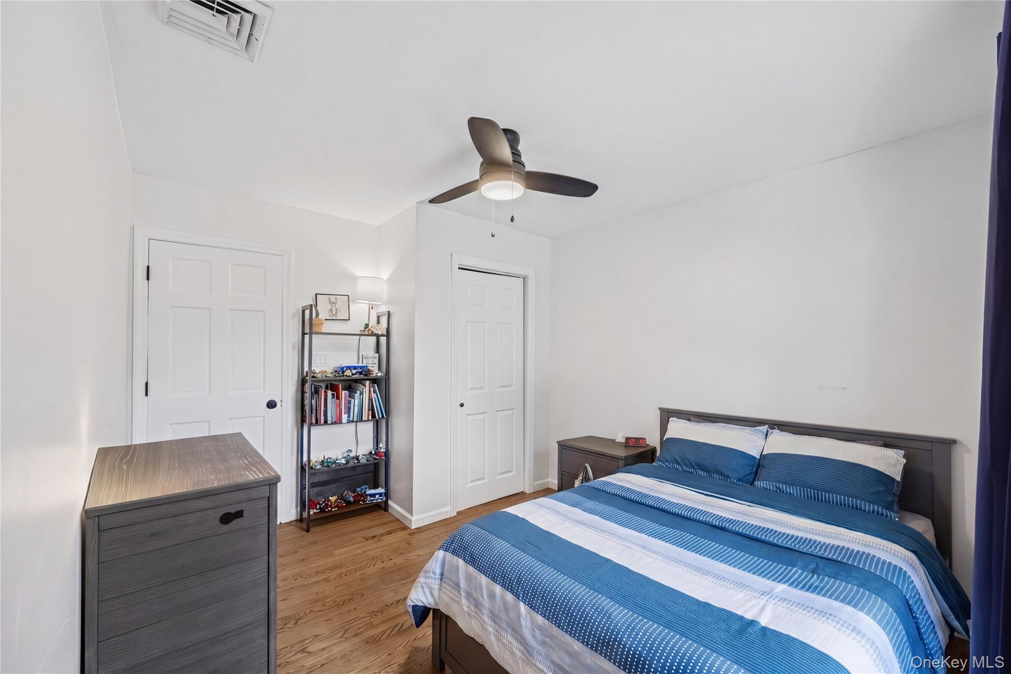 69 Silver Spring Road New Windsor, NY 12553 - Photo 15 of 20 a bedroom with a bed and a chandelier
