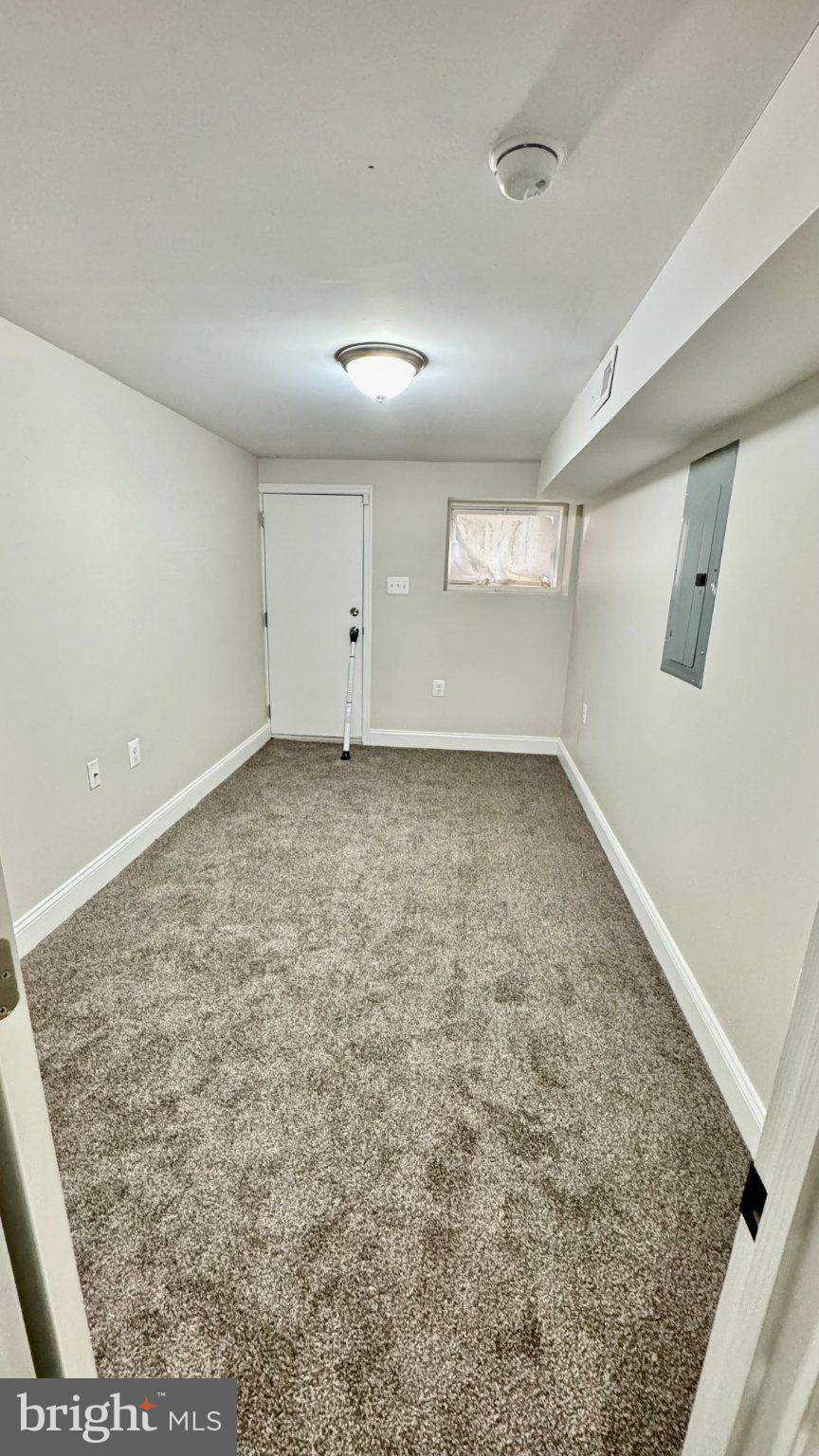 2705 East Biddle Street Baltimore, MD 21213 - Photo 11 of 12 an empty room with a empty space and windows