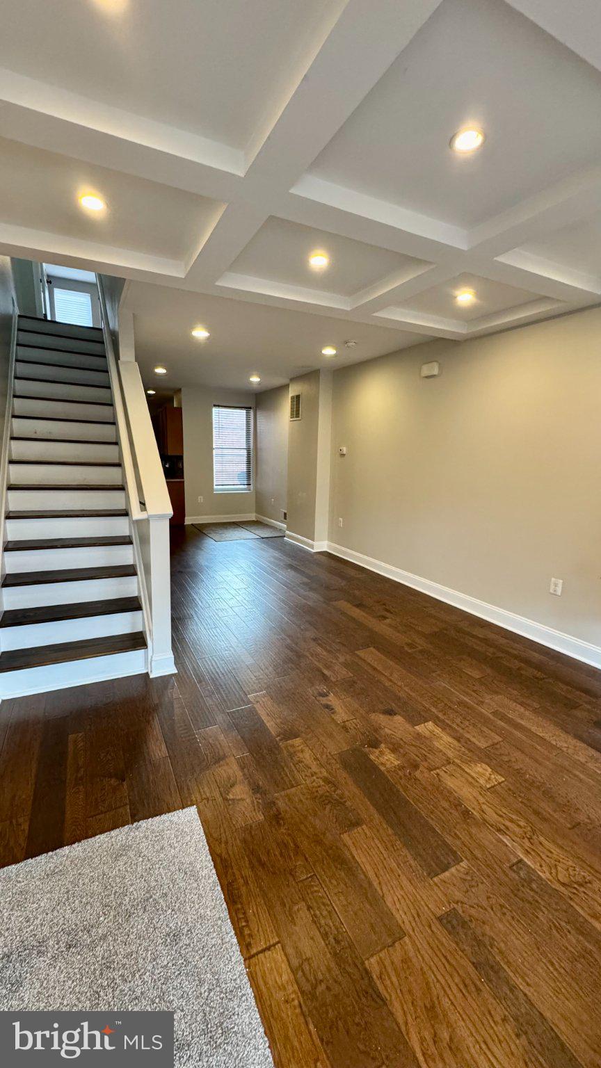 2705 East Biddle Street Baltimore, MD 21213 - Photo 5 of 12 an empty room with wooden floor