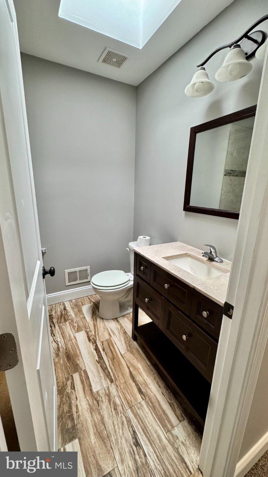 2705 East Biddle Street Baltimore, MD 21213 - Photo 6 of 12 a bathroom with a sink and a mirror