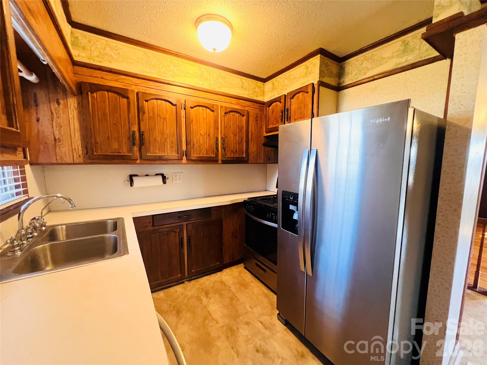 400 Stroupe Street Mount Holly, NC 28120 - Photo 13 of 26 a kitchen with stainless steel appliances a refrigerator and a sink