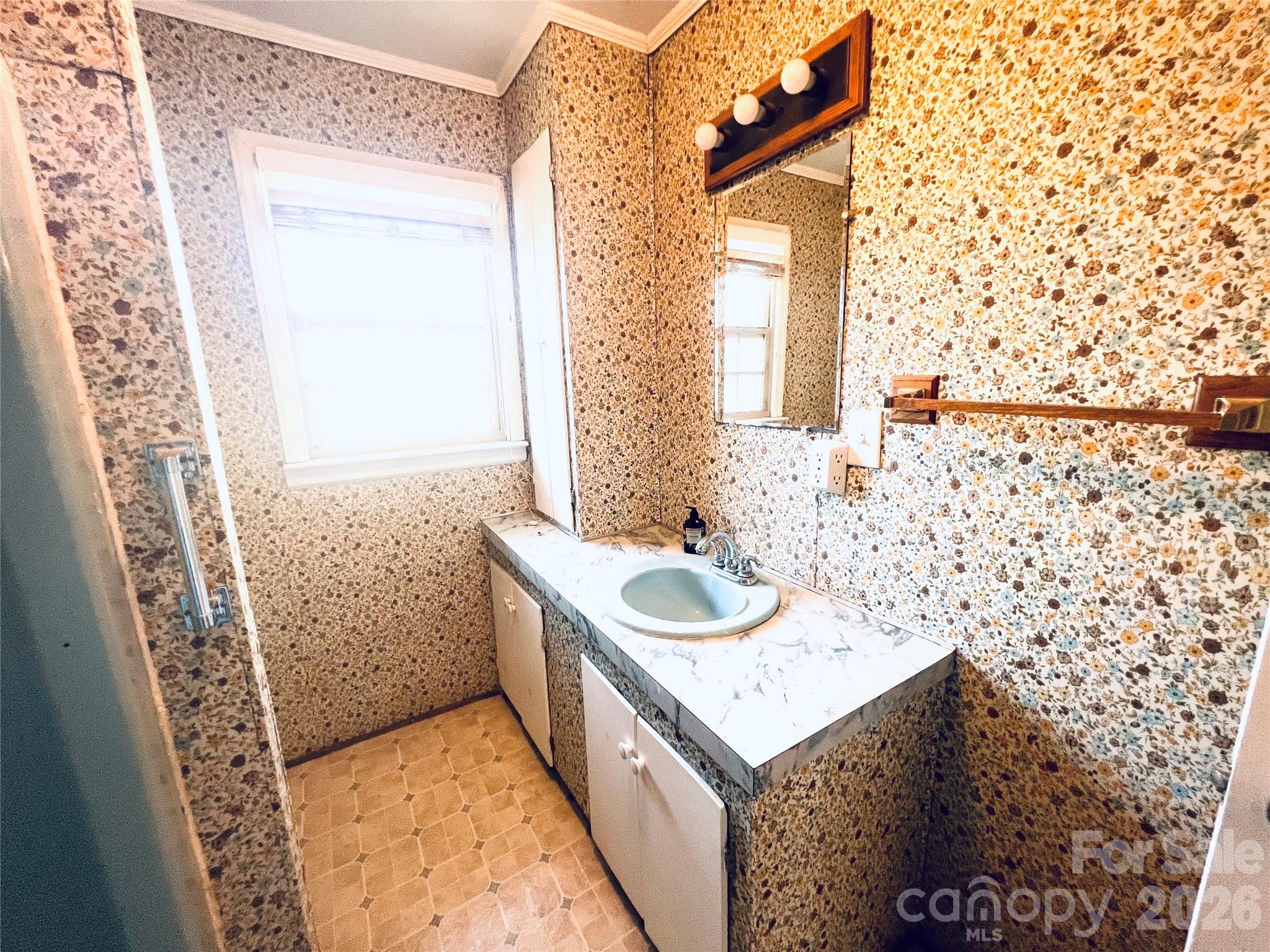 400 Stroupe Street Mount Holly, NC 28120 - Photo 17 of 26 a bathroom with a sink and a mirror