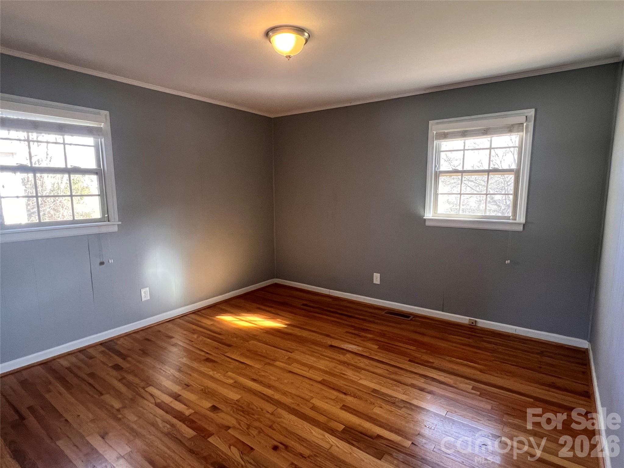 400 Stroupe Street Mount Holly, NC 28120 - Photo 18 of 26 a view of an empty room with wooden floor and a window