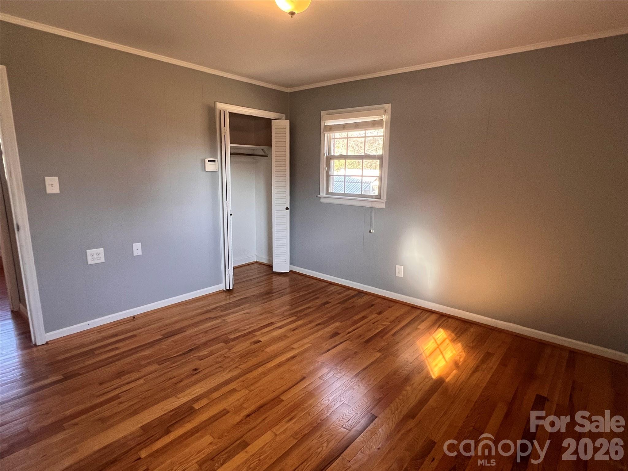 400 Stroupe Street Mount Holly, NC 28120 - Photo 19 of 26 a view of empty room with wooden floor and fan