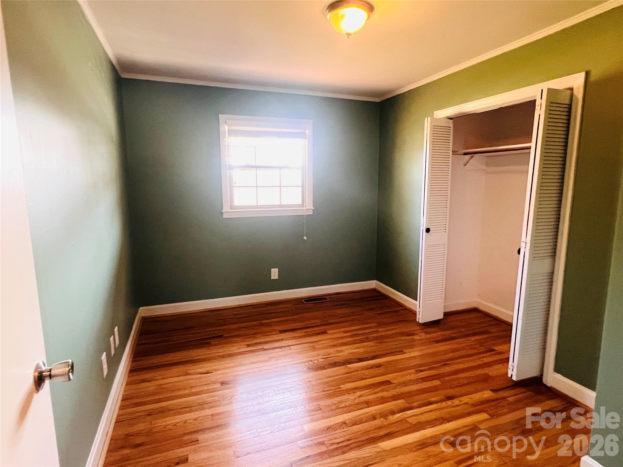400 Stroupe Street Mount Holly, NC 28120 - Photo 21 of 26 a view of empty room with wooden floor