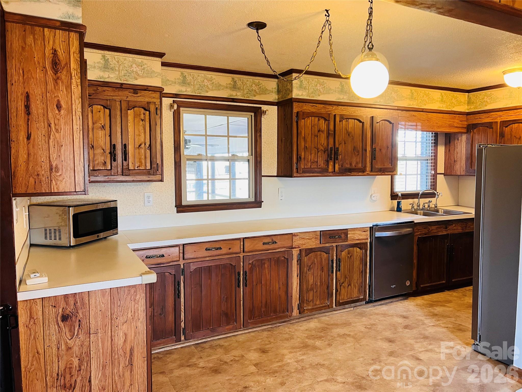 400 Stroupe Street Mount Holly, NC 28120 - Photo 6 of 26 a kitchen with stainless steel appliances granite countertop a stove a sink dishwasher and a refrigerator with wooden floor