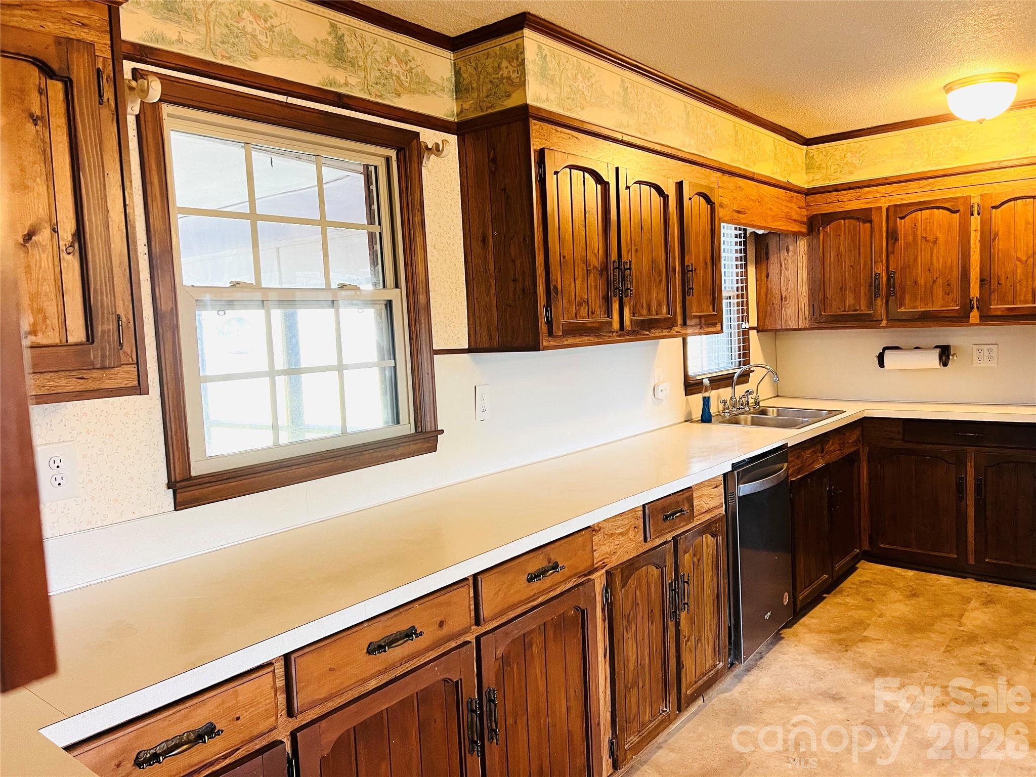 400 Stroupe Street Mount Holly, NC 28120 - Photo 7 of 26 a kitchen with stainless steel appliances sink cabinets and window