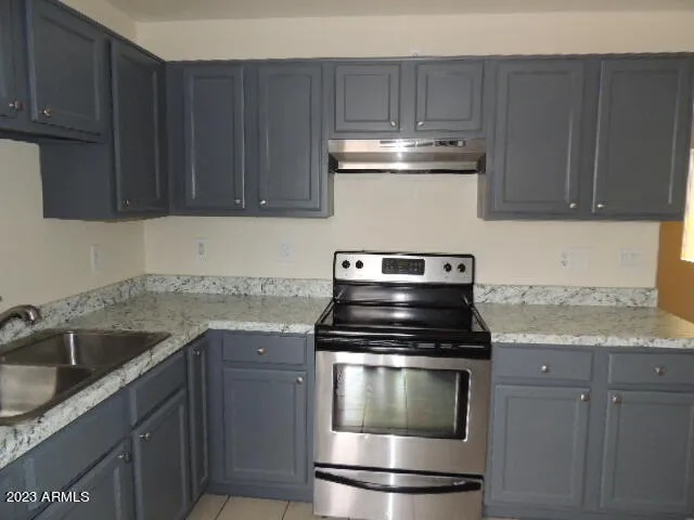 a kitchen with a sink stove and microwave