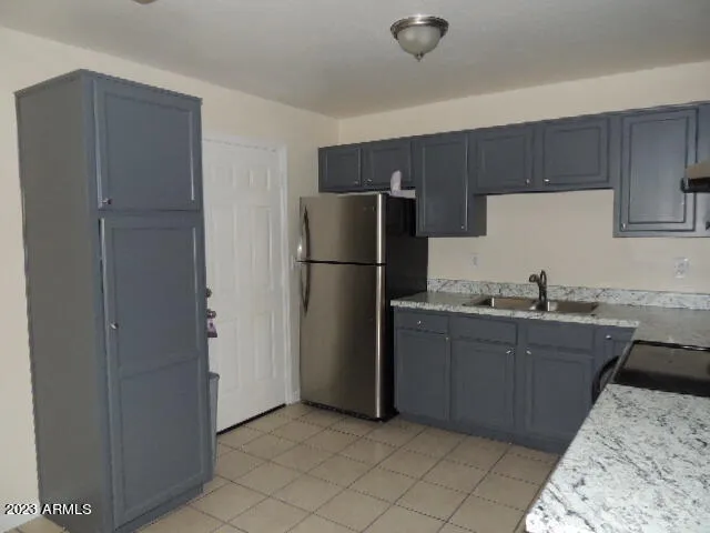 a kitchen with a refrigerator and a sink