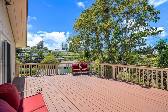 a balcony with wooden floor and fence