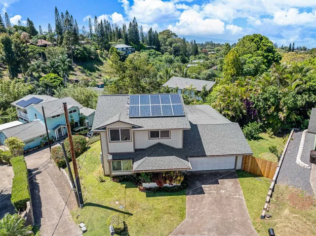 an aerial view of a house with swimming pool garden and patio