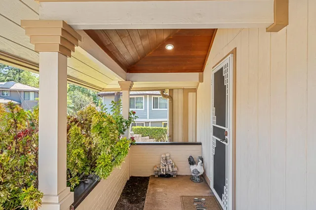 a view of a house with a yard and sitting area