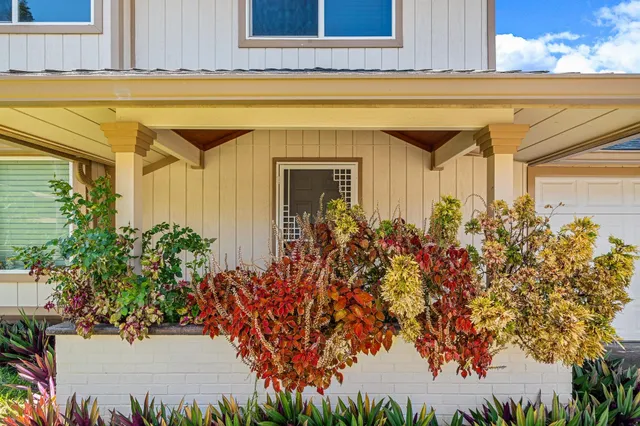 a view of a house with a flower garden