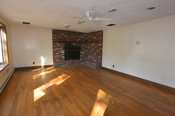 5 Spring Road Middleton, MA 01949 - Photo 2 of 16 a view of empty room with wooden floor and fan