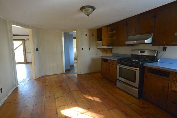 5 Spring Road Middleton, MA 01949 - Photo 7 of 16 a kitchen with stainless steel appliances granite countertop a stove a sink and a refrigerator