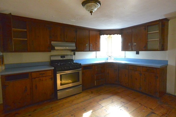 5 Spring Road Middleton, MA 01949 - Photo 8 of 16 a kitchen with granite countertop wood cabinets stainless steel appliances and a window