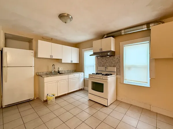 a kitchen with cabinets oven and a sink