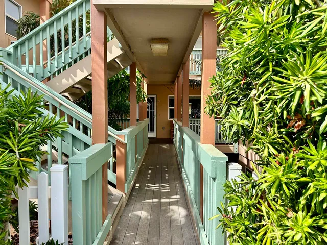 a view of an chairs and flower in front of house