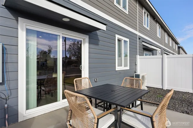 a backyard of a house with table and chairs