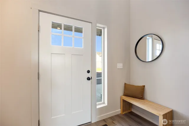 a bathroom with a toilet and a mirror