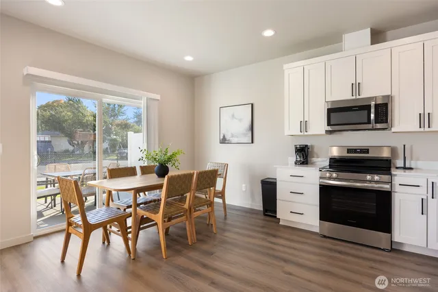 a view of kitchen with microwave stove top oven and cabinets