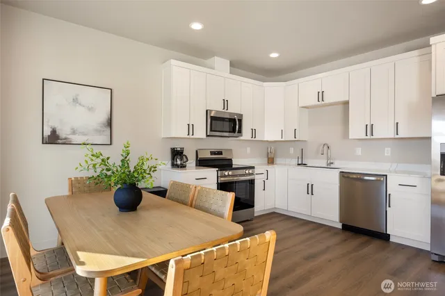 a kitchen with a sink cabinets and wooden floor