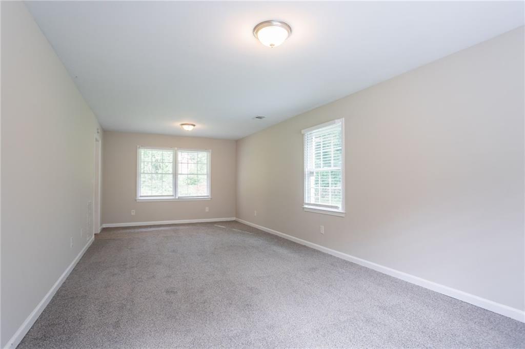 542 Hasty Drive Lithia Springs, GA 30122 - Photo 15 of 44 an empty room with windows