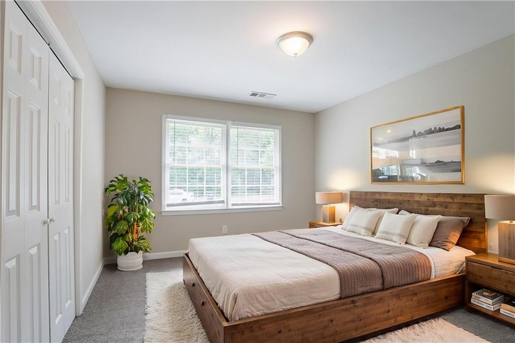 542 Hasty Drive Lithia Springs, GA 30122 - Photo 16 of 44 a bedroom with a bed and a window