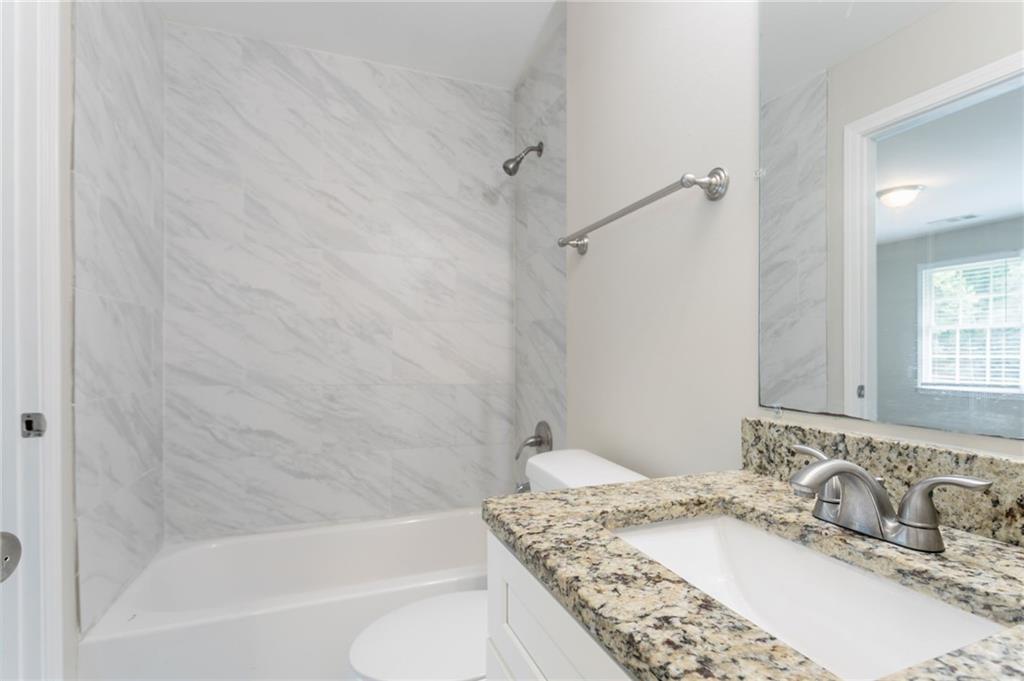 542 Hasty Drive Lithia Springs, GA 30122 - Photo 19 of 44 a bathroom with a granite countertop sink and a mirror