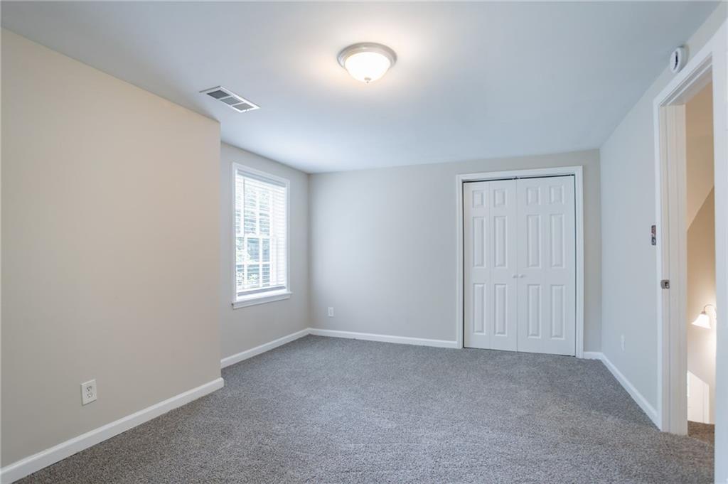 542 Hasty Drive Lithia Springs, GA 30122 - Photo 21 of 44 a view of an empty room with a window