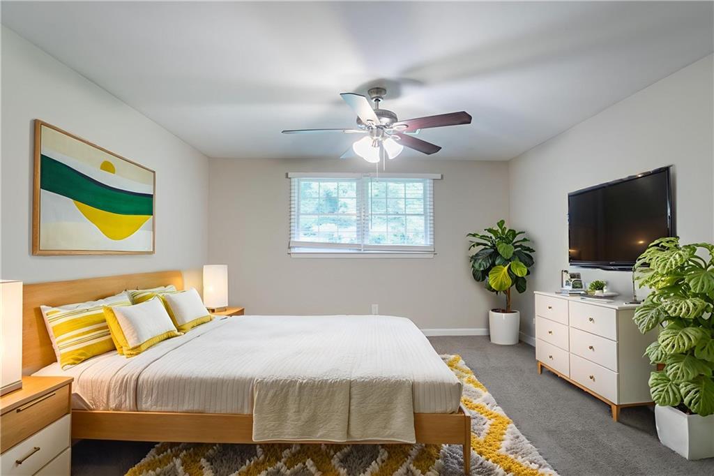 542 Hasty Drive Lithia Springs, GA 30122 - Photo 27 of 44 a bedroom with a bed and a flat screen tv