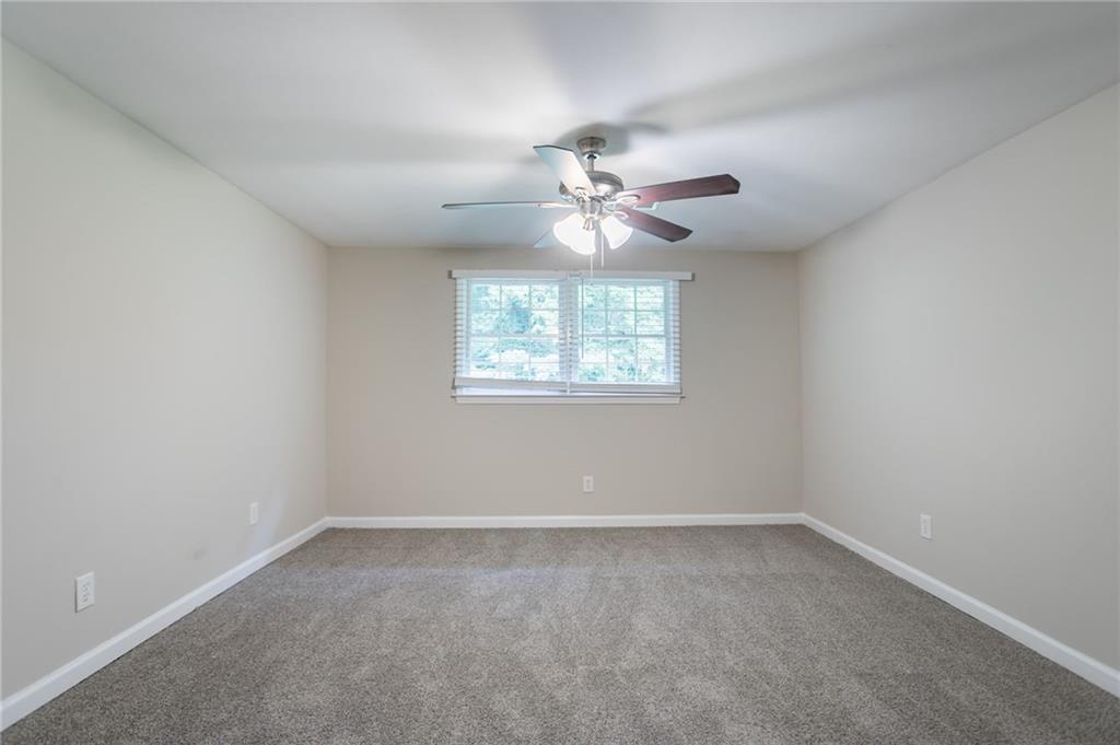 542 Hasty Drive Lithia Springs, GA 30122 - Photo 28 of 44 an empty room with a window and a fan