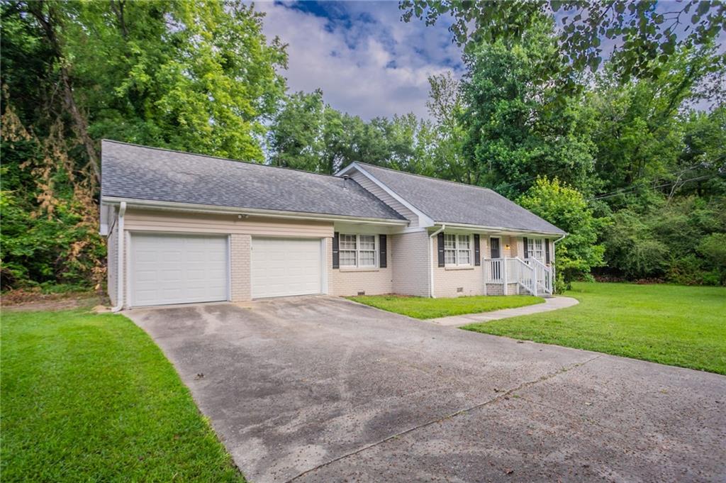 542 Hasty Drive Lithia Springs, GA 30122 - Photo 3 of 44 a front view of a house with a yard and garage