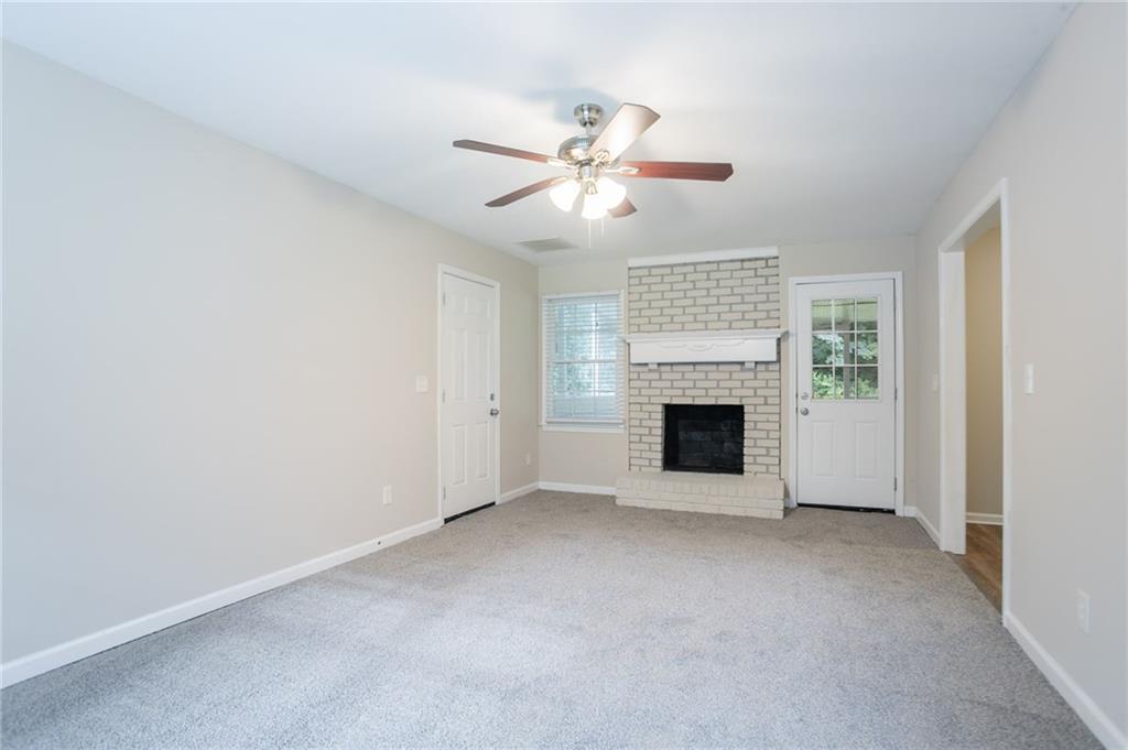 542 Hasty Drive Lithia Springs, GA 30122 - Photo 5 of 44 a view of a livingroom with a fireplace and fan