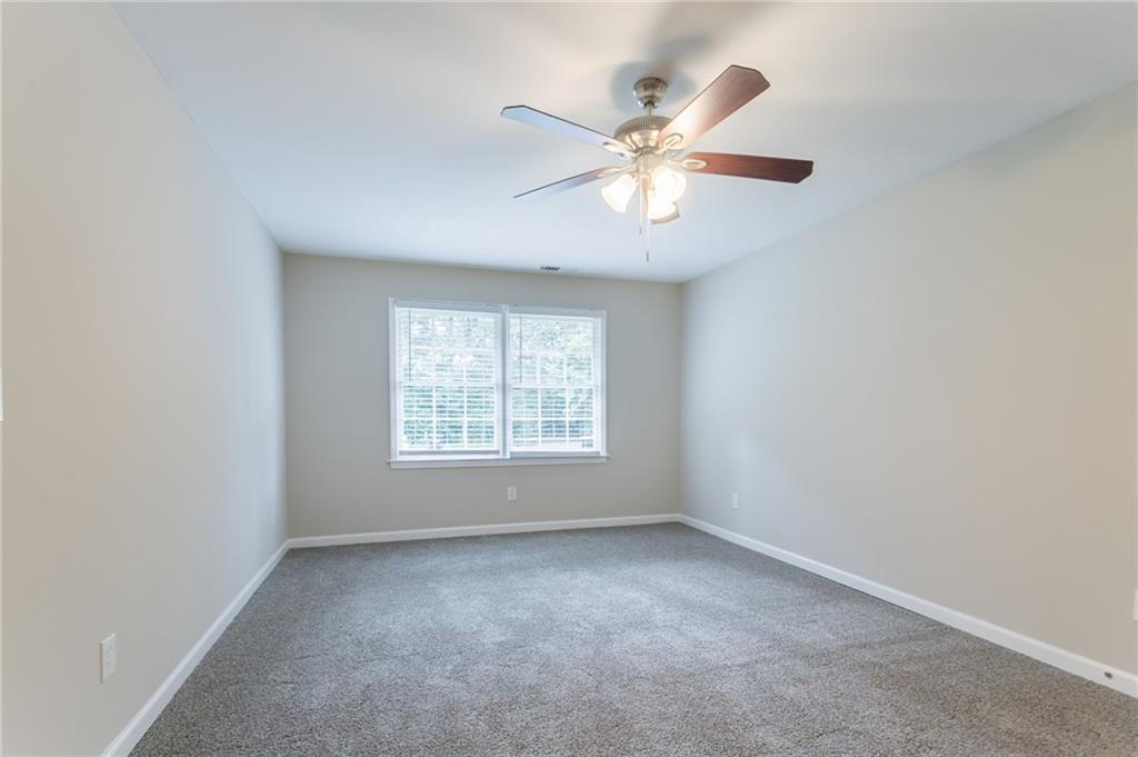 542 Hasty Drive Lithia Springs, GA 30122 - Photo 6 of 44 an empty room with windows and fan