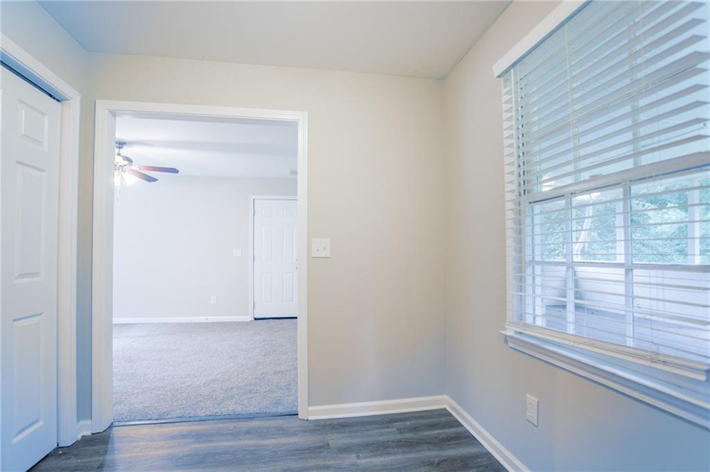 542 Hasty Drive Lithia Springs, GA 30122 - Photo 9 of 44 a view of an empty room with wooden floor and a window
